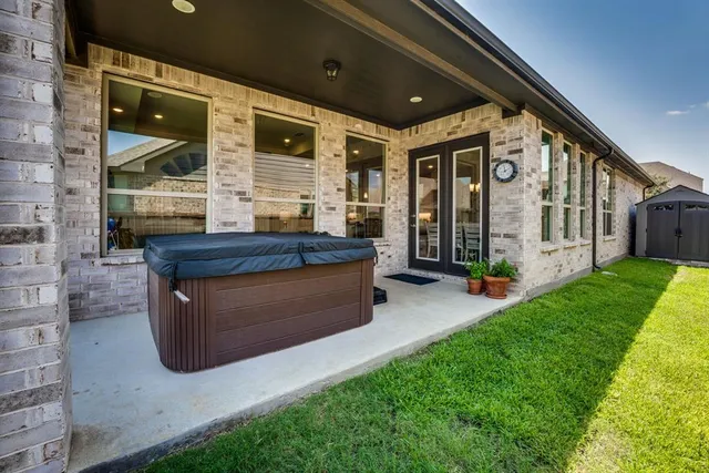 a view of a porch with furniture and garden