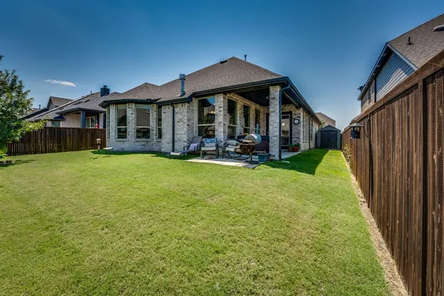 a front view of a house with a garden and yard