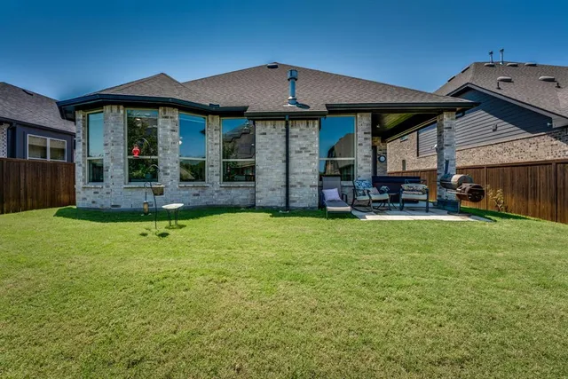 a view of a house with a yard porch and sitting area