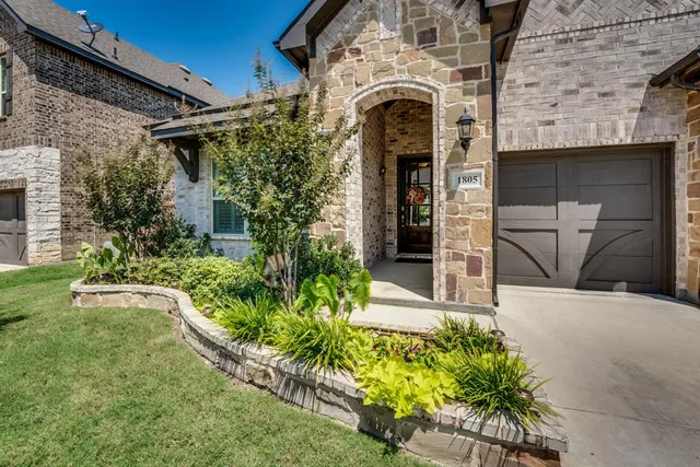 a front view of a house with a garden and patio