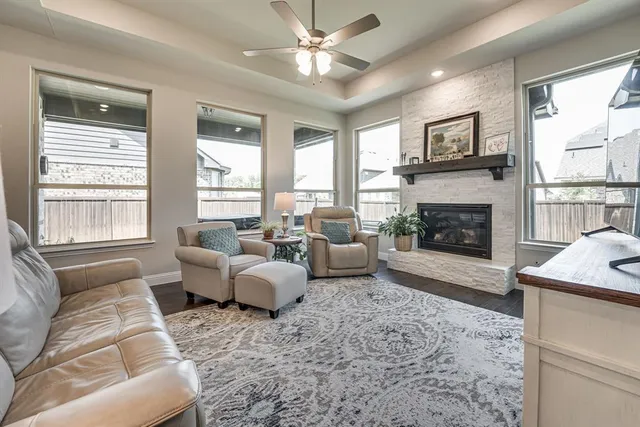 a living room with furniture fireplace and a large window