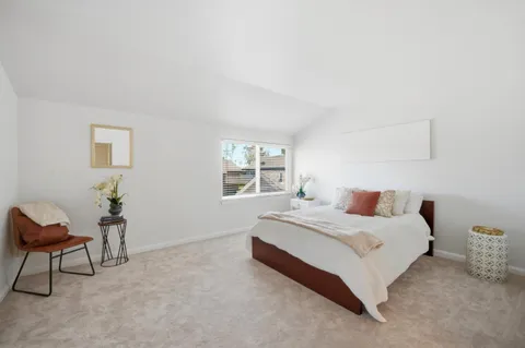 a spacious bedroom with a bed and a couch