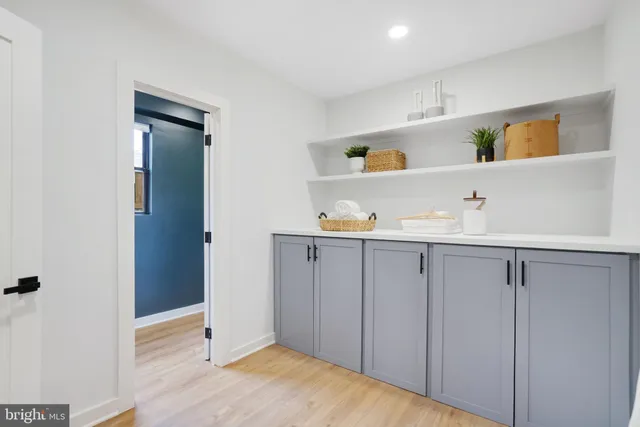 a view of kitchen cabinets and wooden floor