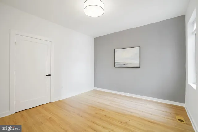 a view of a room with wooden floor and bathroom