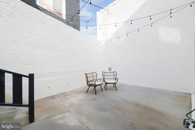 a view of a room with table and chairs