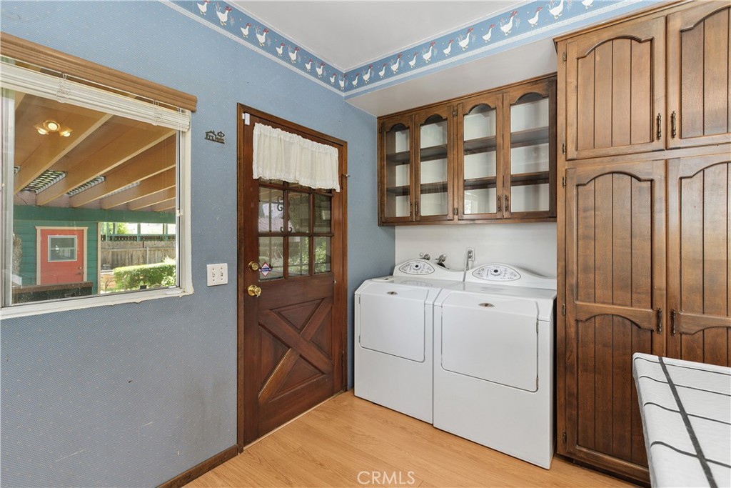 3892 Oakwood Place Riverside, CA 92506 - Photo 15 of 36 Laundry room view featuring convenient proximity to the back door, which opens onto a covered patio overlooking the scenic rear gardens.