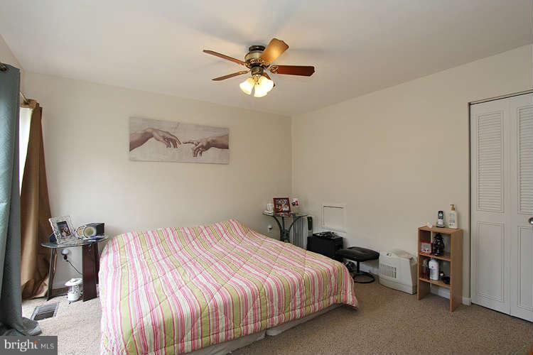 3343 Claridge Court Silver Spring, MD 20902 - Photo 16 of 20 a bedroom with a bed and a chandelier