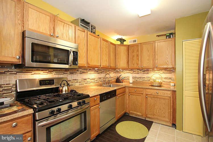 3343 Claridge Court Silver Spring, MD 20902 - Photo 5 of 20 a kitchen with stainless steel appliances a stove a sink and a microwave