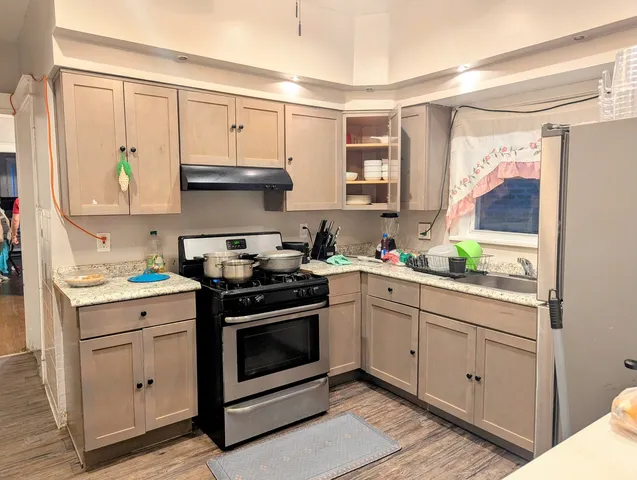 a kitchen with white cabinets and appliances