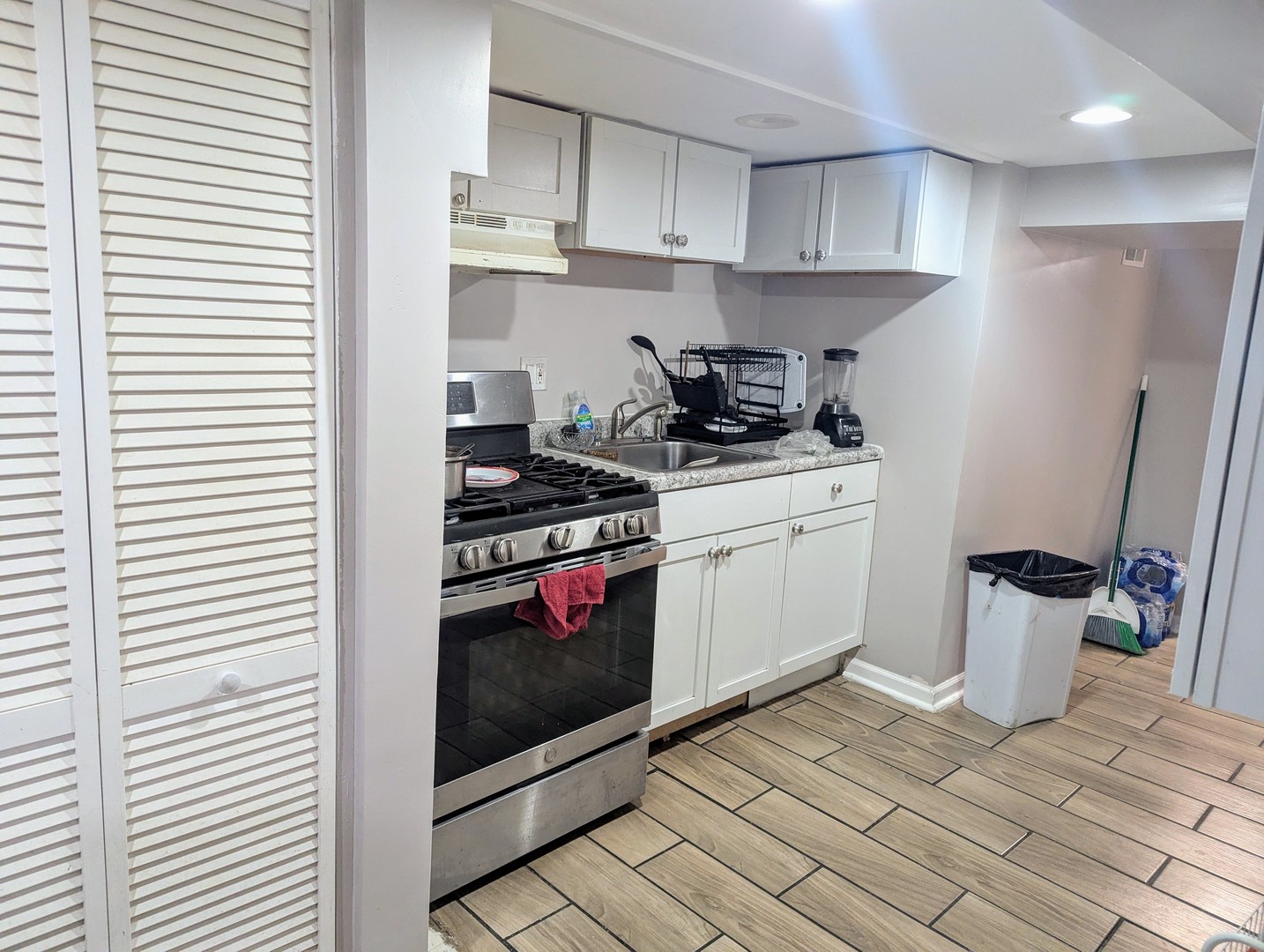 4949 West Iowa Street Chicago, IL 60651 - Photo 6 of 13 a kitchen with stainless steel appliances a white stove top oven and a refrigerator