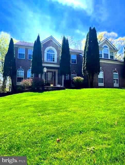 5113 Robins Perch Lane Perry Hall, MD 21128 - Photo 1 of 16 a view of a brick building next to a yard with big trees