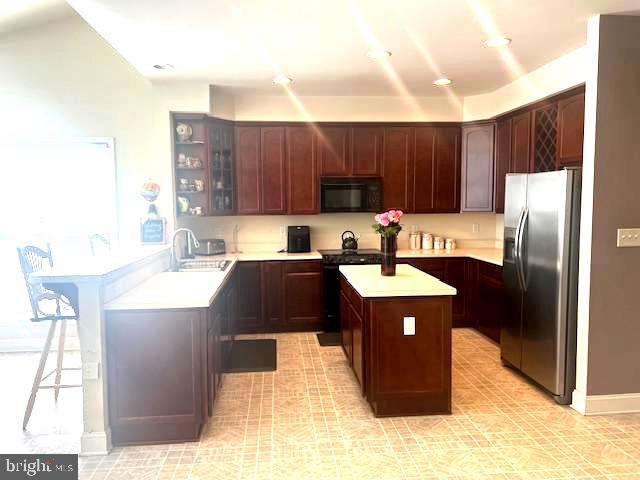 5113 Robins Perch Lane Perry Hall, MD 21128 - Photo 3 of 16 a kitchen with a refrigerator a sink and a cabinets