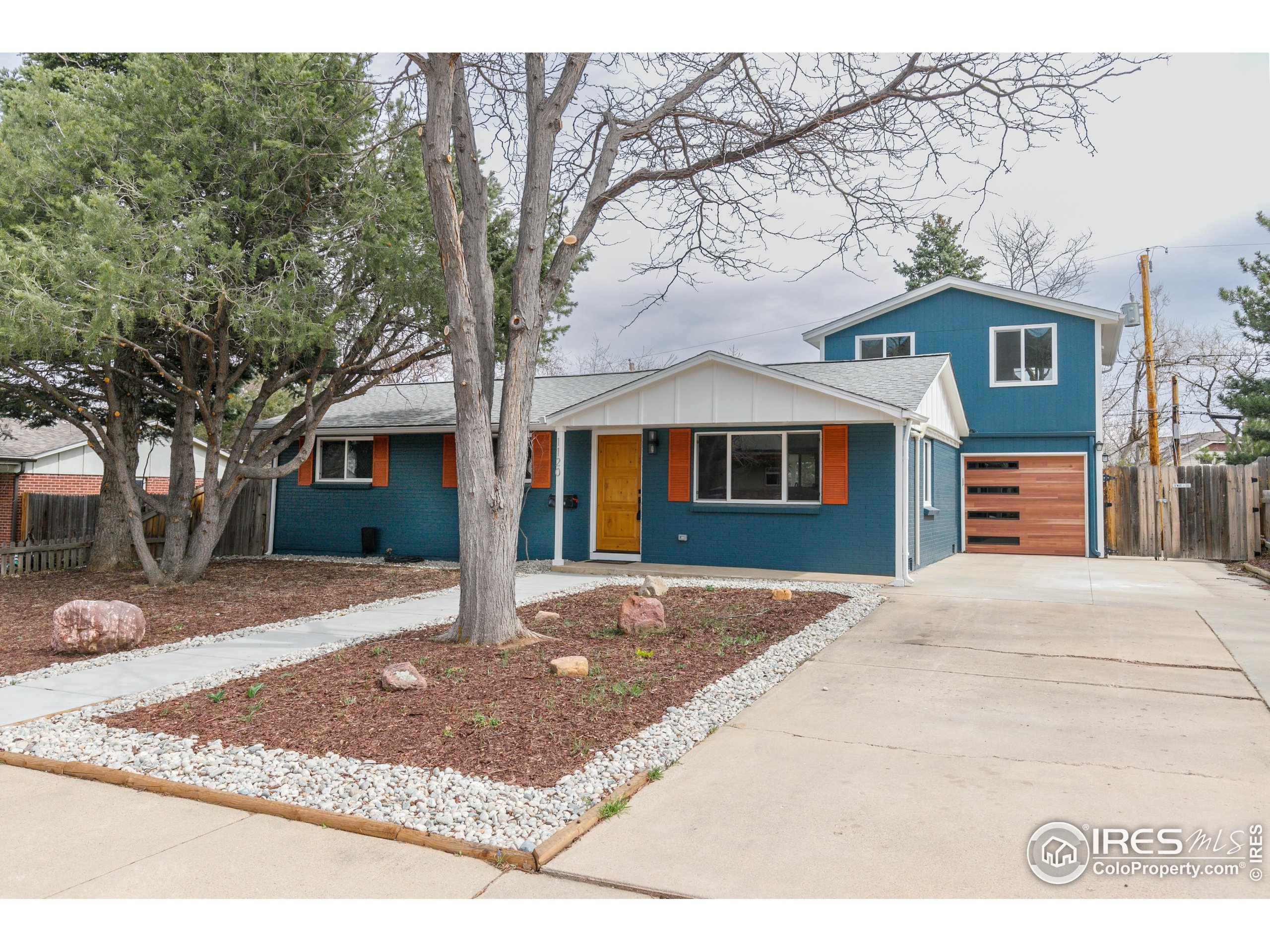 1120 Hartford Drive Boulder, CO 80305 - Photo 1 of 40 a front view of a house with a yard and garage