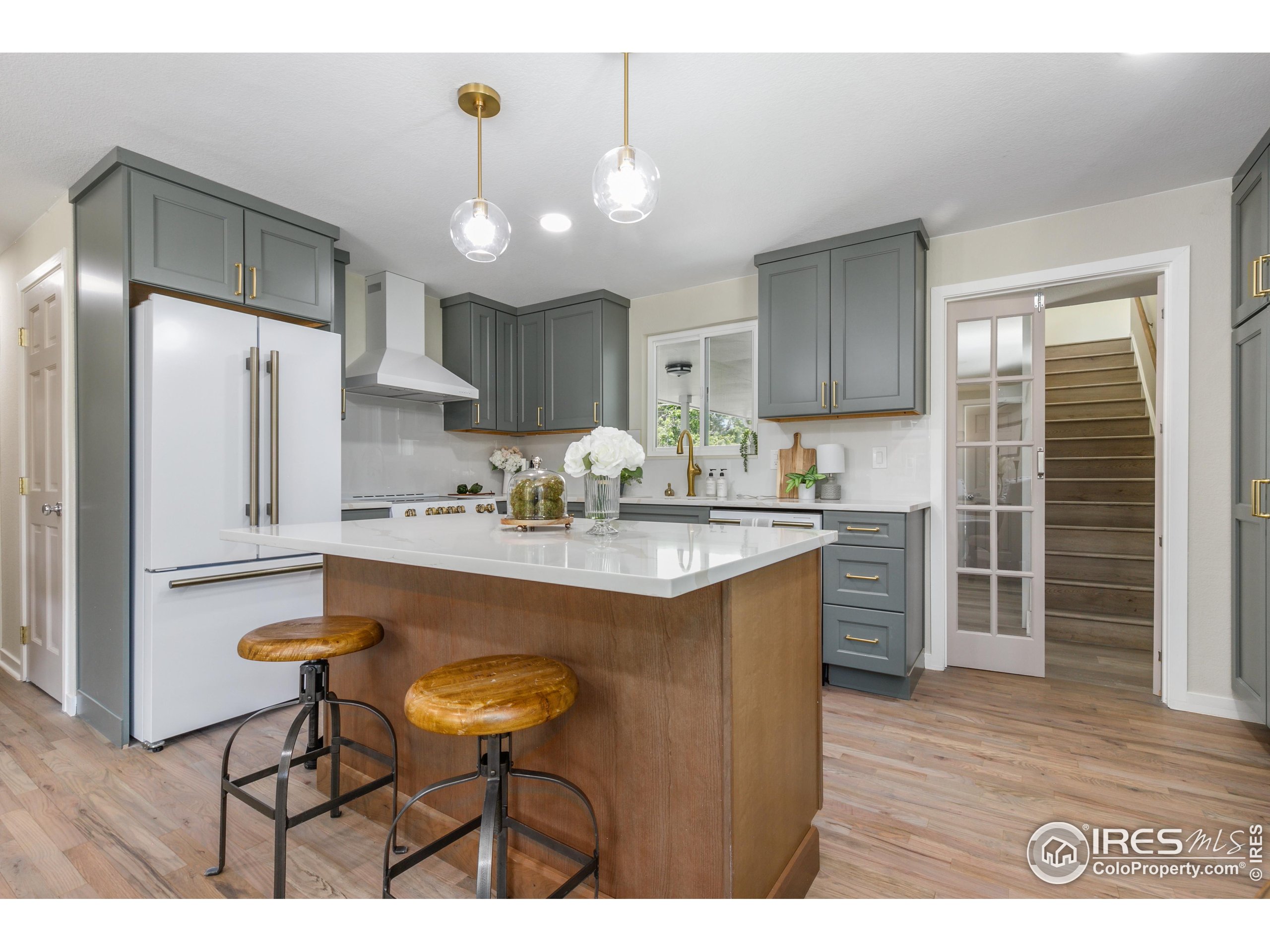1120 Hartford Drive Boulder, CO 80305 - Photo 13 of 40 a kitchen with kitchen island stainless steel appliances a sink cabinets and wooden floor
