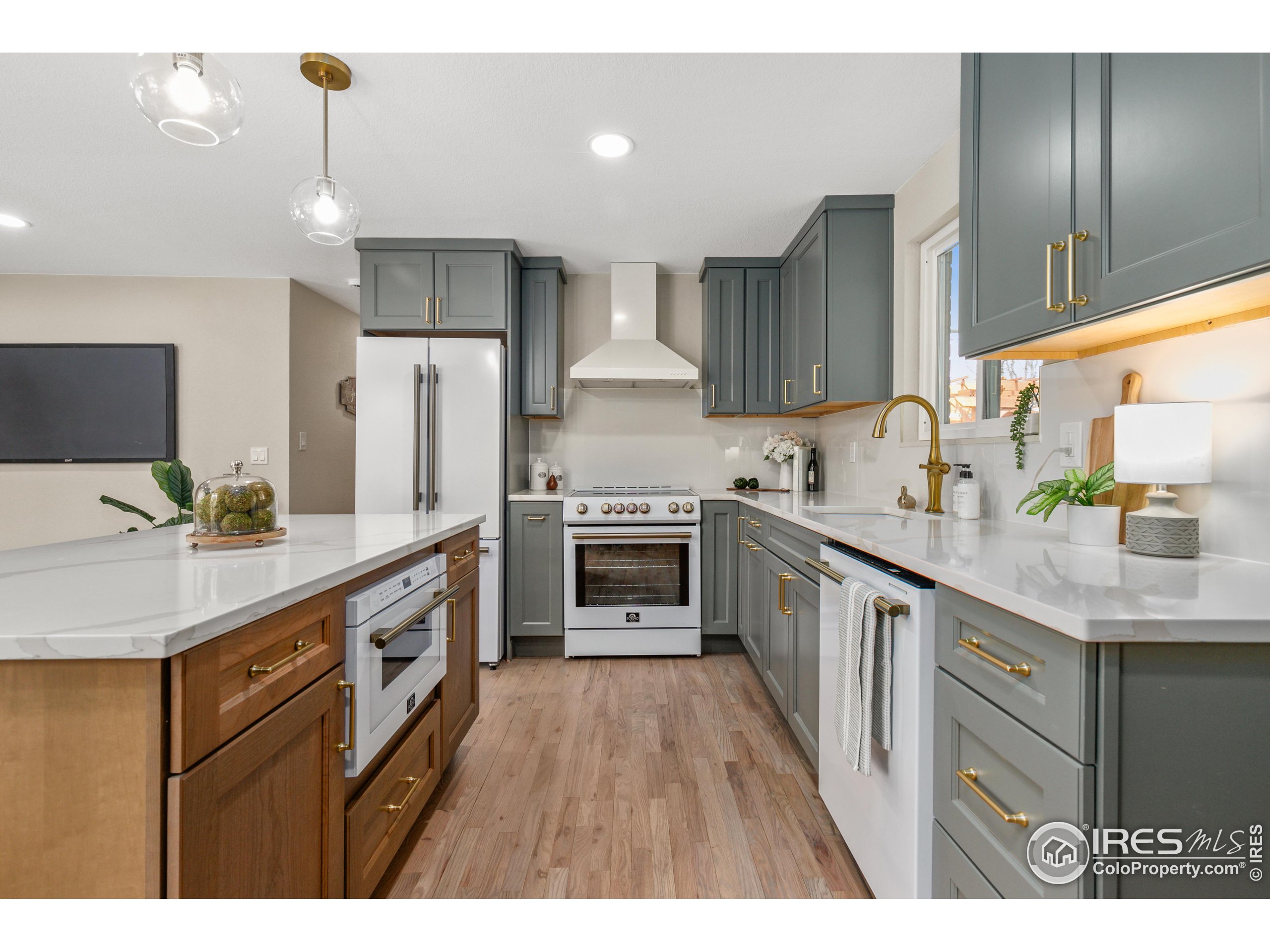 1120 Hartford Drive Boulder, CO 80305 - Photo 14 of 40 a kitchen with granite countertop a sink cabinets and stainless steel appliances
