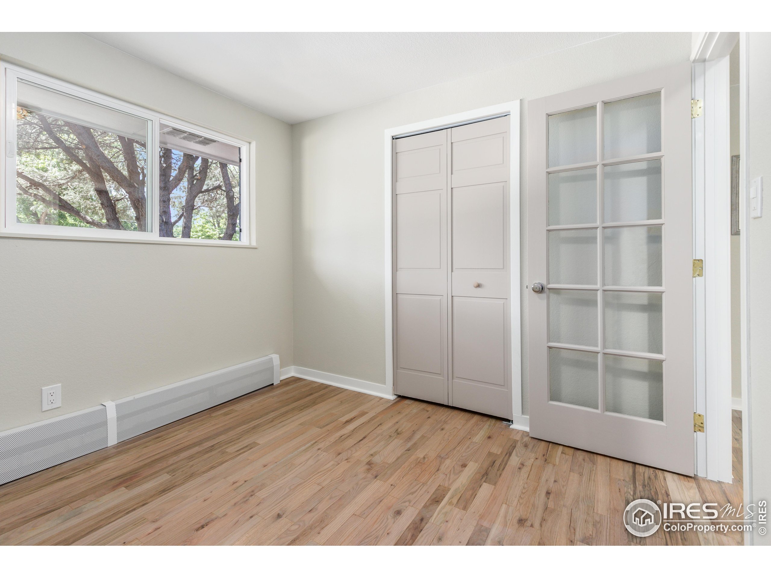 1120 Hartford Drive Boulder, CO 80305 - Photo 17 of 40 a view of an empty room with wooden floor and closet