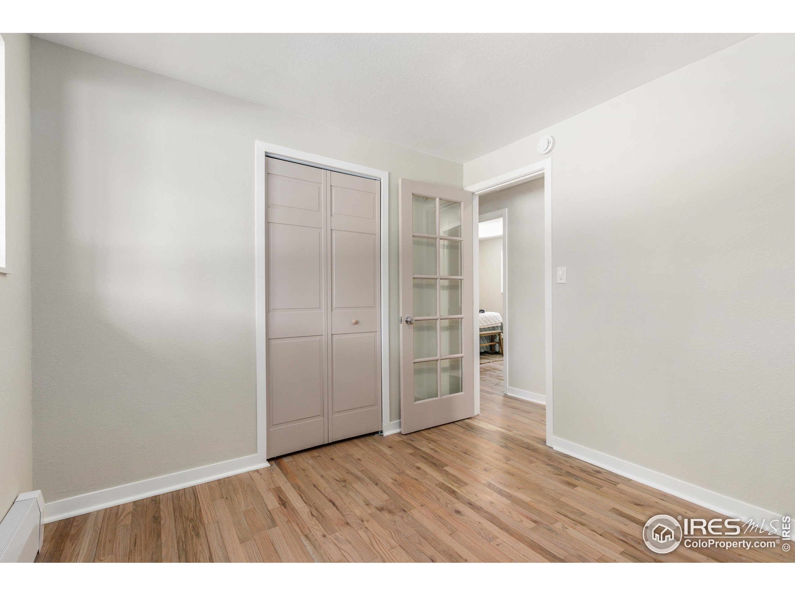 1120 Hartford Drive Boulder, CO 80305 - Photo 18 of 40 a view of an empty room with wooden floor