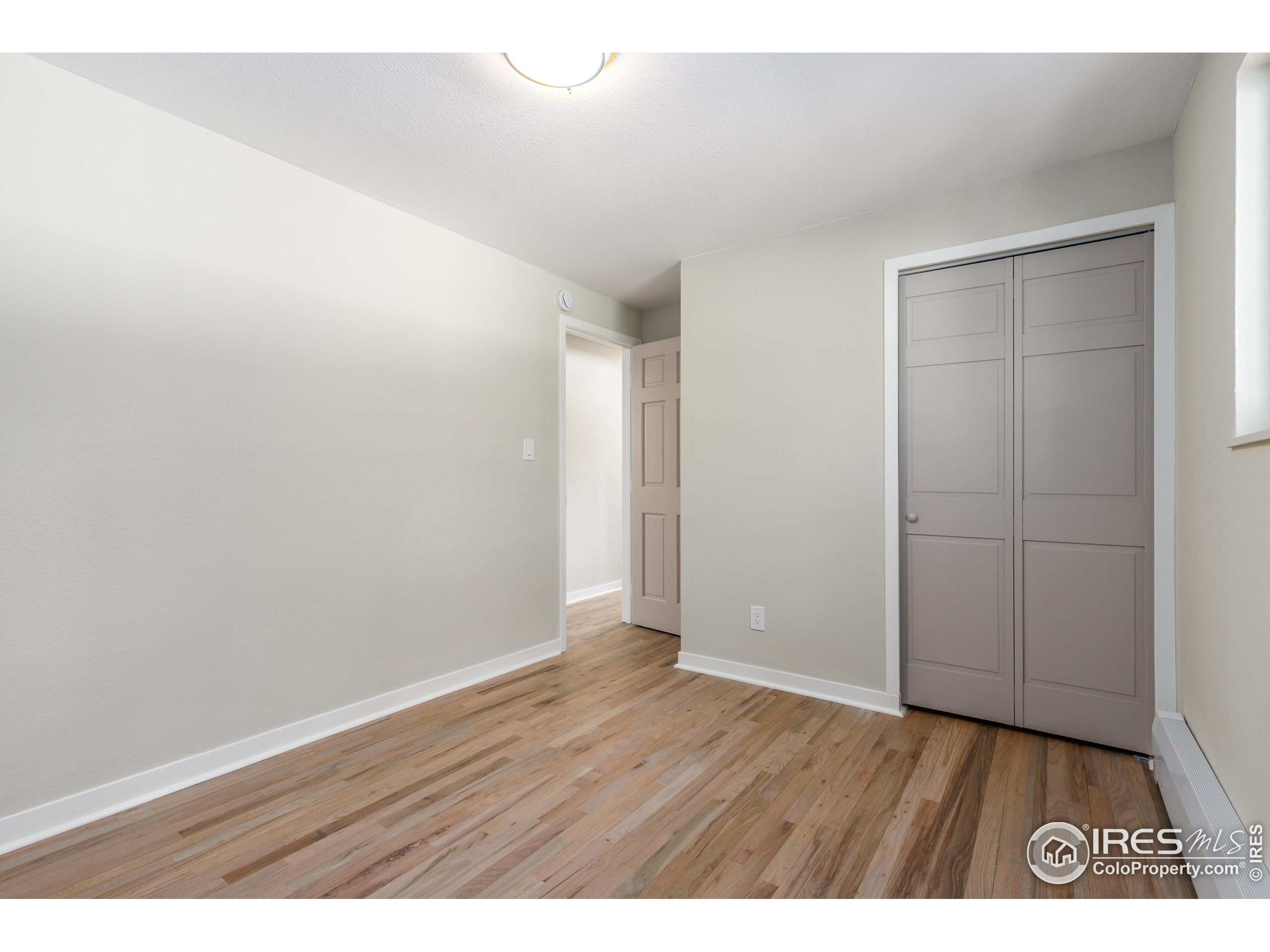 1120 Hartford Drive Boulder, CO 80305 - Photo 21 of 40 a view of an empty room with wooden floor