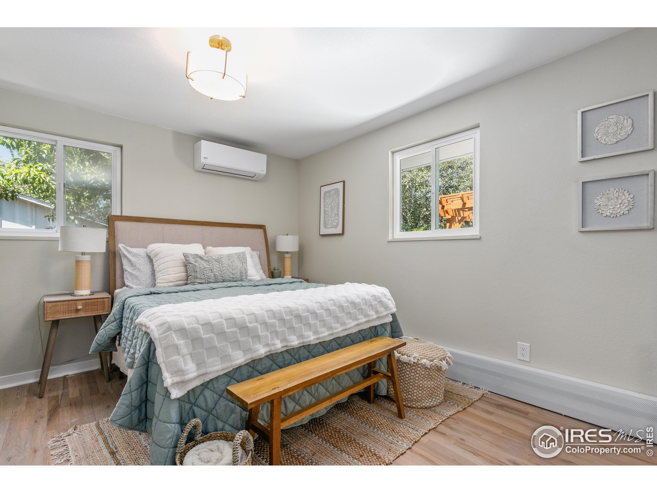 1120 Hartford Drive Boulder, CO 80305 - Photo 23 of 40 a bedroom with a bed and a painting on the wall
