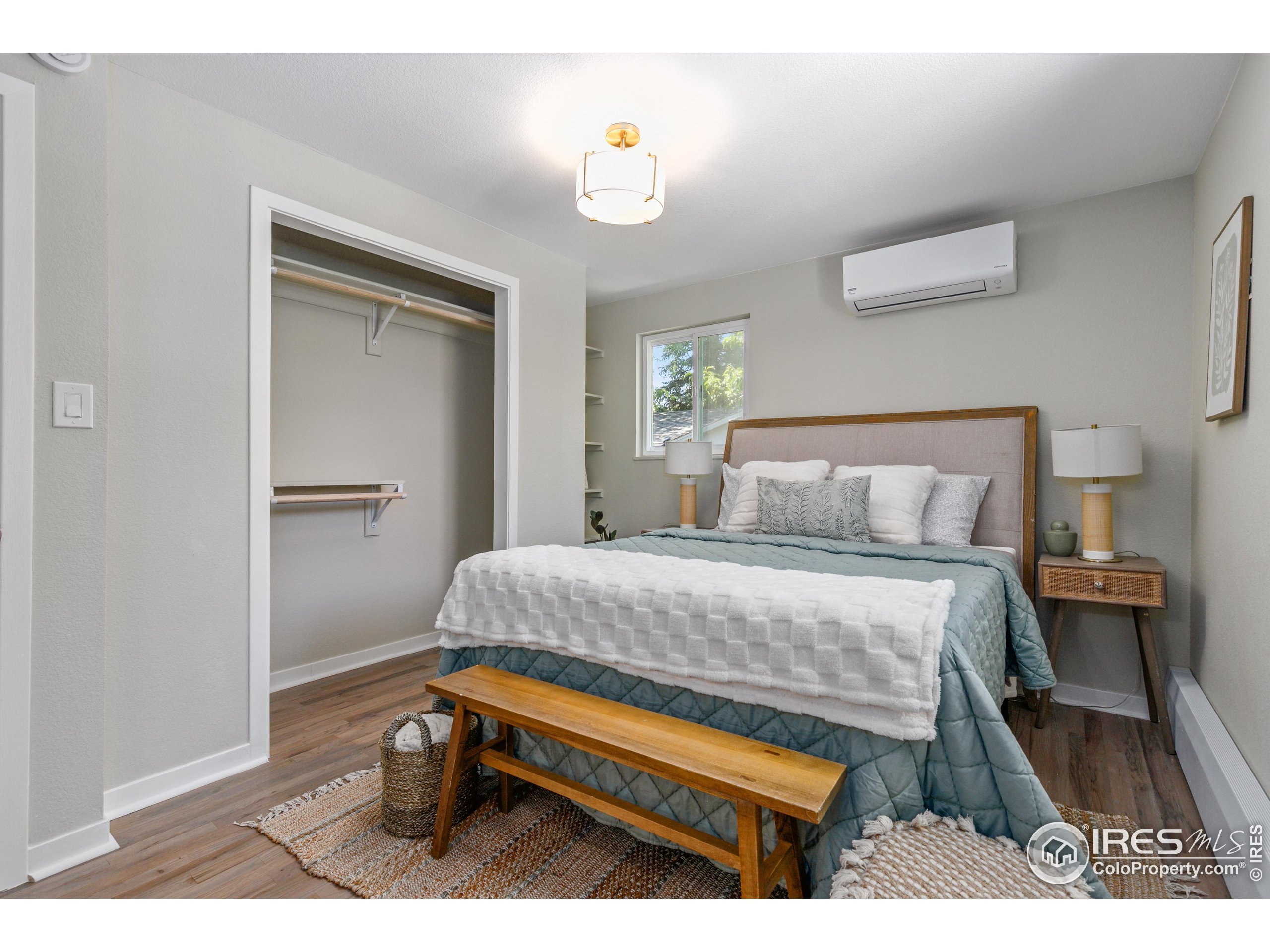1120 Hartford Drive Boulder, CO 80305 - Photo 25 of 40 a bedroom with a bed and a lamp on table