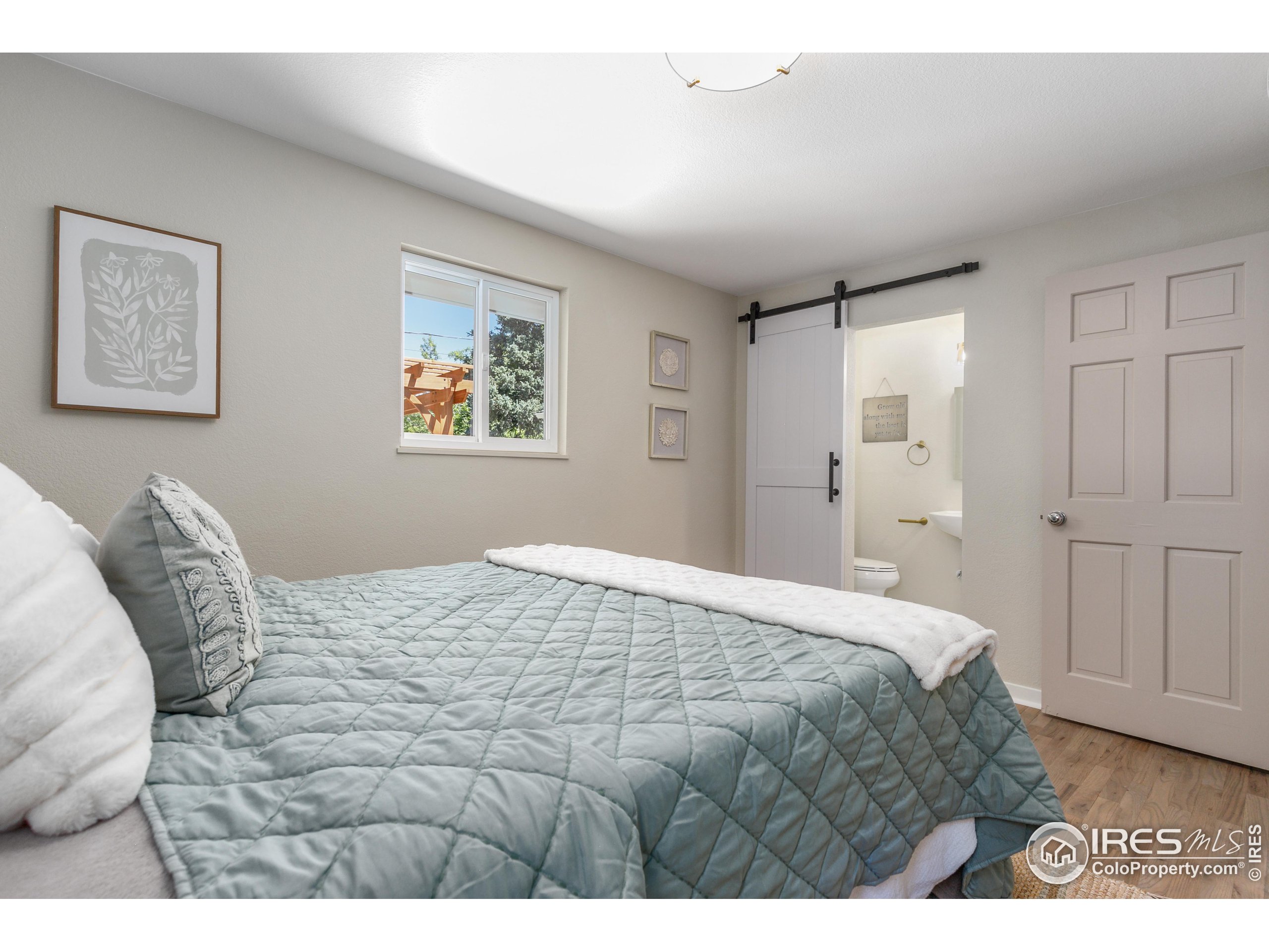 1120 Hartford Drive Boulder, CO 80305 - Photo 26 of 40 a bedroom with a bed and a painting on the wall