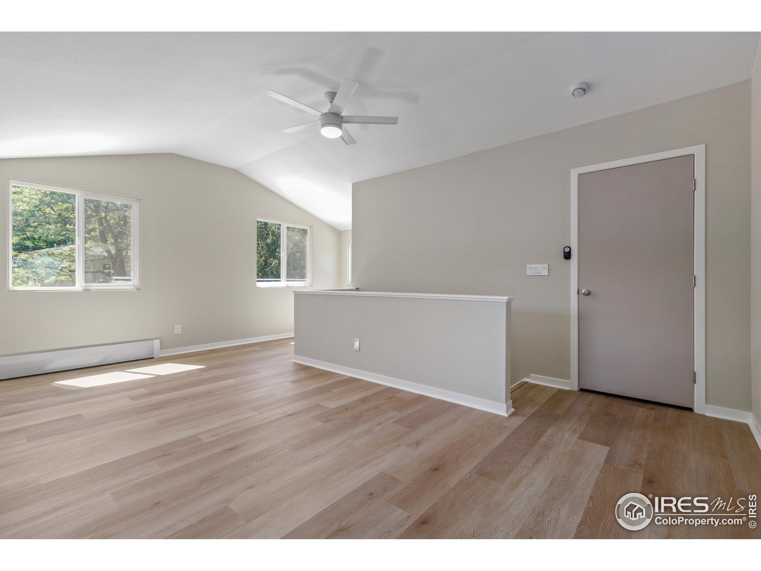 1120 Hartford Drive Boulder, CO 80305 - Photo 31 of 40 a view of an empty room with wooden floor and a window