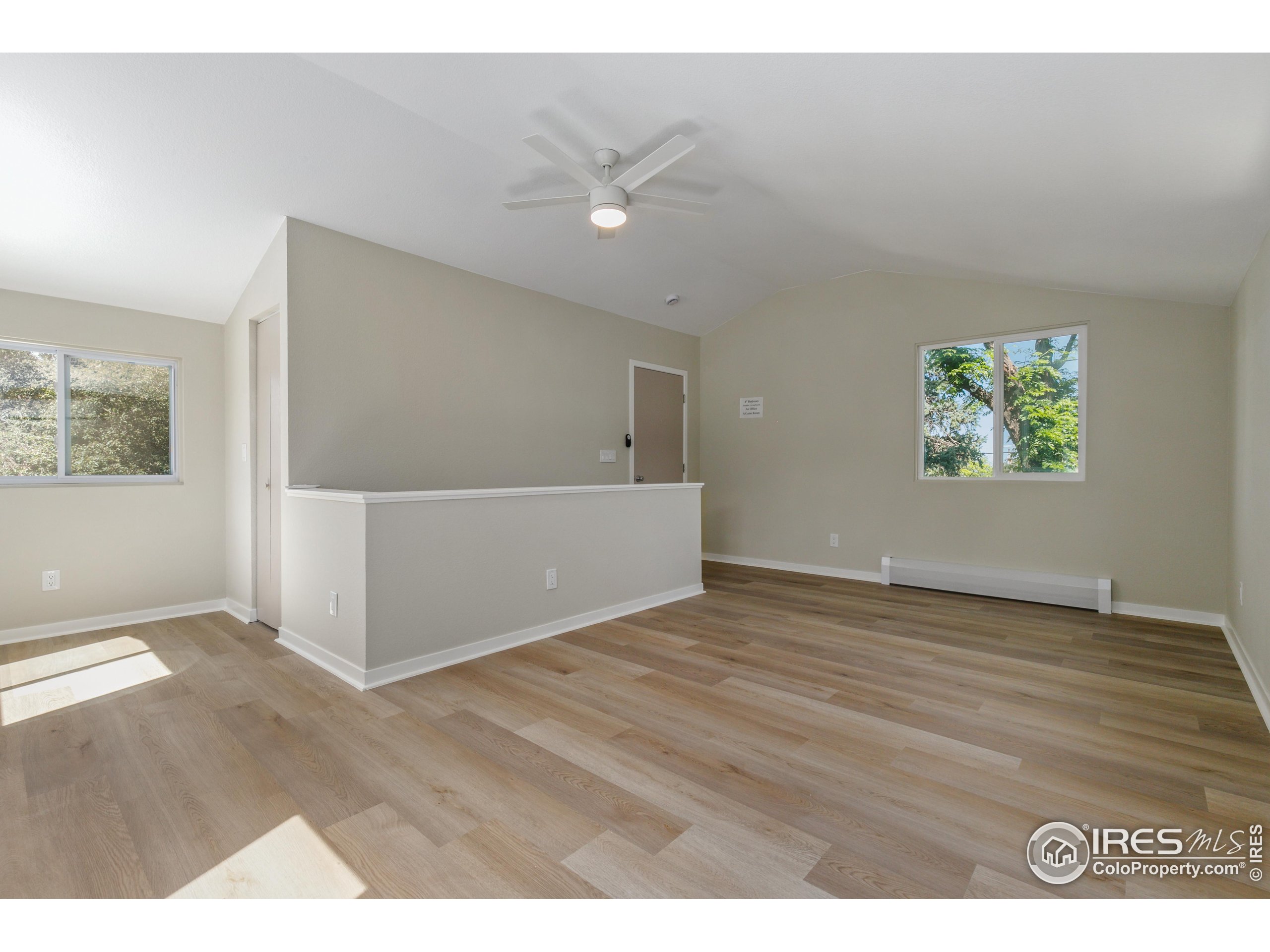 1120 Hartford Drive Boulder, CO 80305 - Photo 32 of 40 a view of an empty room with wooden floor and a window