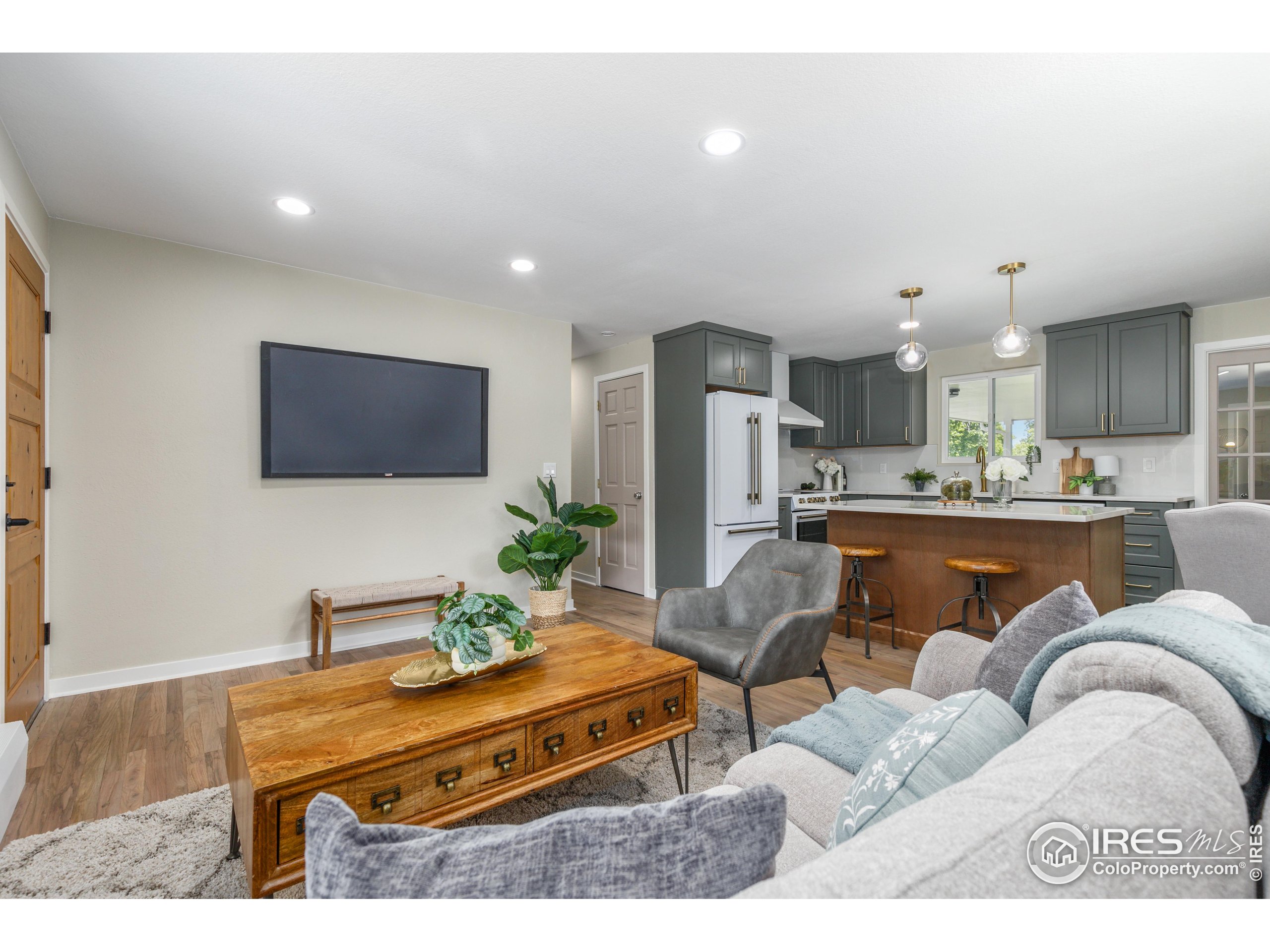 1120 Hartford Drive Boulder, CO 80305 - Photo 10 of 40 a living room with furniture kitchen view and a flat screen tv