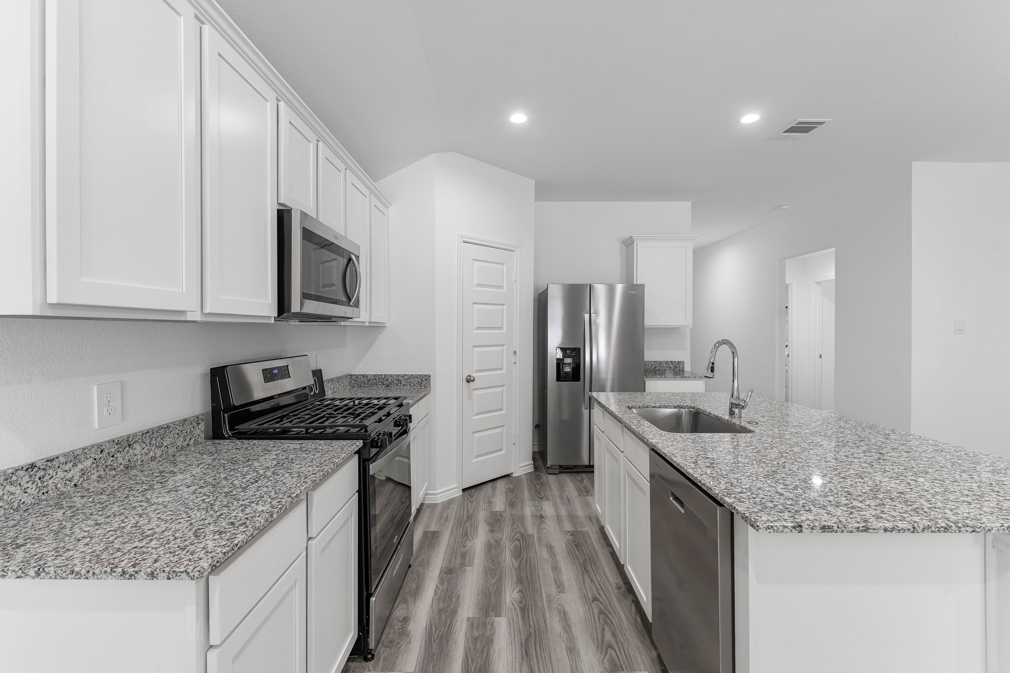 545 Hunter Grove Lane Beaumont, TX 77713 - Photo 5 of 26 a kitchen with stainless steel appliances granite countertop a sink stove and refrigerator