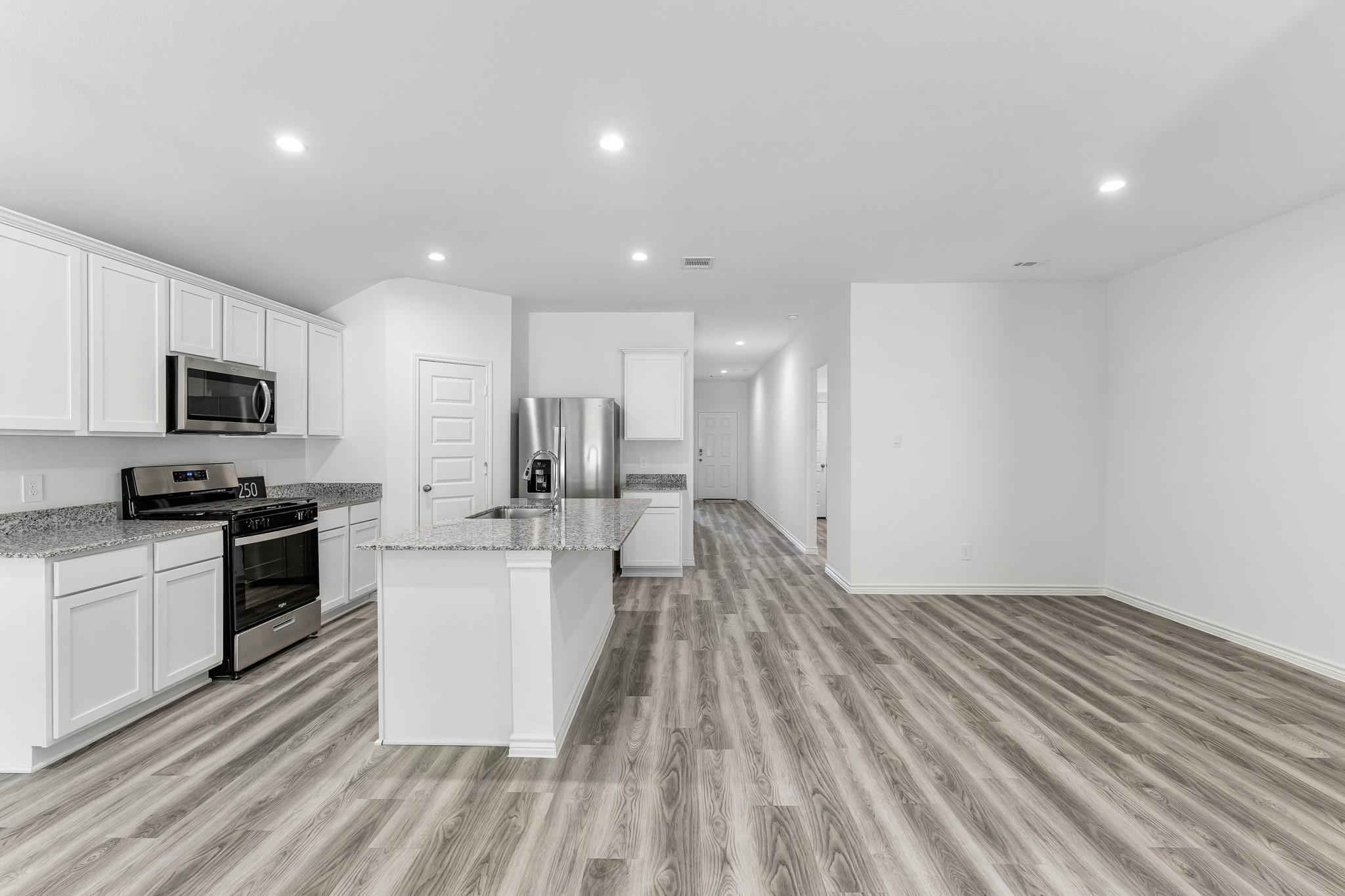 545 Hunter Grove Lane Beaumont, TX 77713 - Photo 6 of 26 a large kitchen with a sink and stainless steel appliances