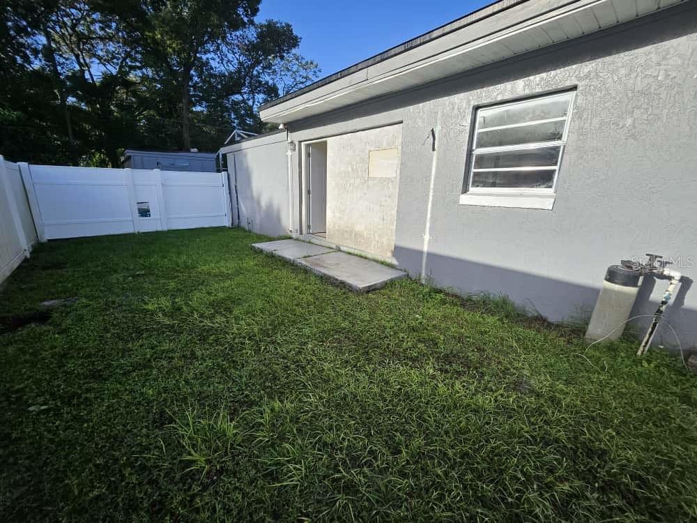 7406 Nolton Way Orlando, FL 32822 - Photo 3 of 10 a view of house with backyard and garden