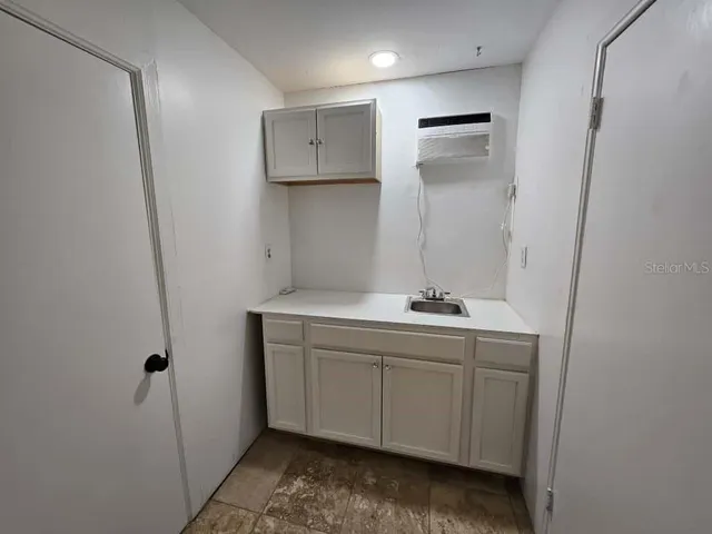 a room with a sink and cabinets