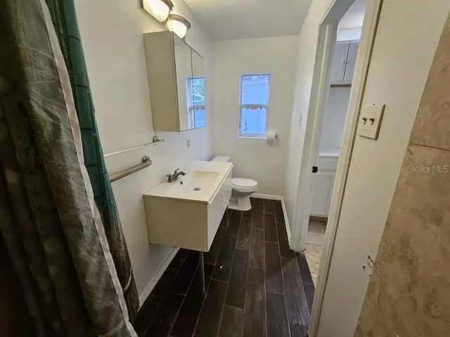 a bathroom with a sink a mirror and a toilet
