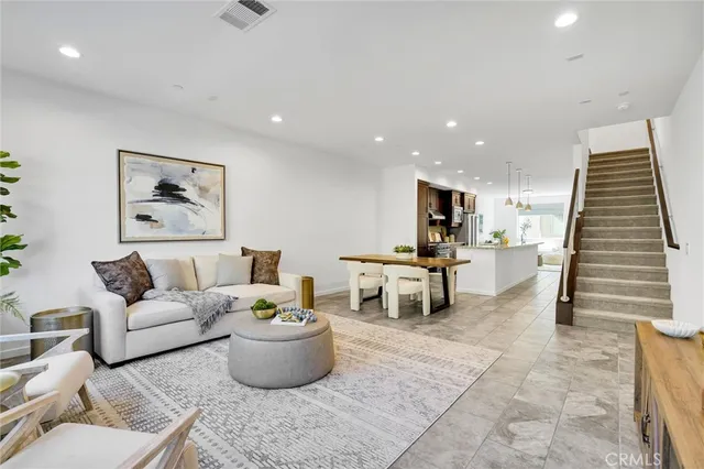 a living room with furniture and kitchen view