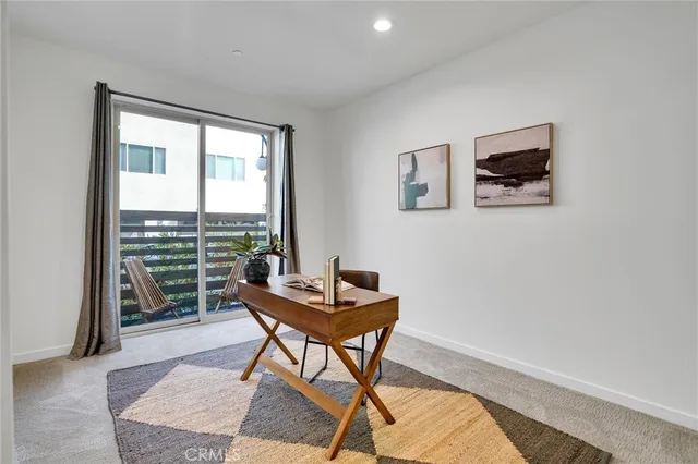 a workspace room with furniture and a window