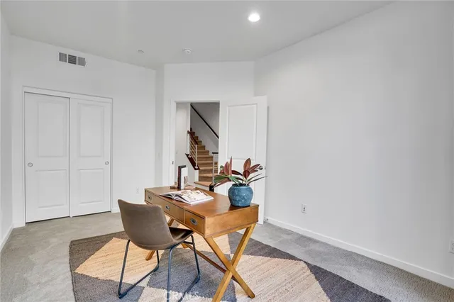 a work room with furniture and a potted plant
