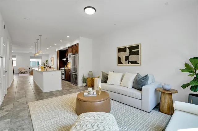 a living room with furniture and kitchen view