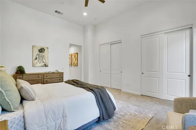 a bedroom with a bed and a couch