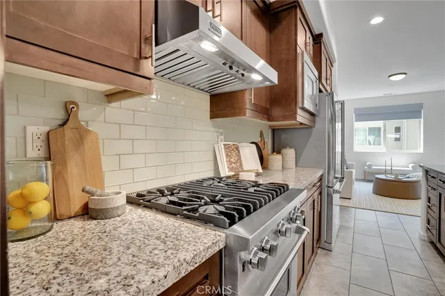 a kitchen with a stove and a wooden cabinets
