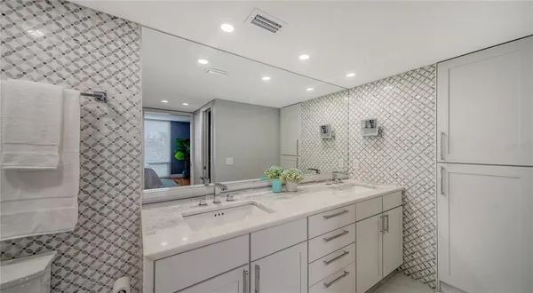 a bathroom with a double vanity sink and a mirror