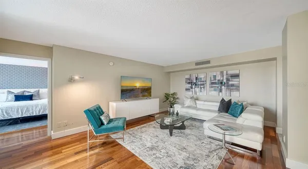 a living room with furniture and wooden floor