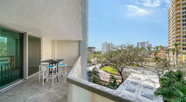 a view of a chairs and table in a balcony