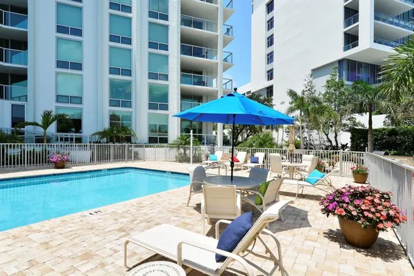 a swimming pool with outdoor seating and yard