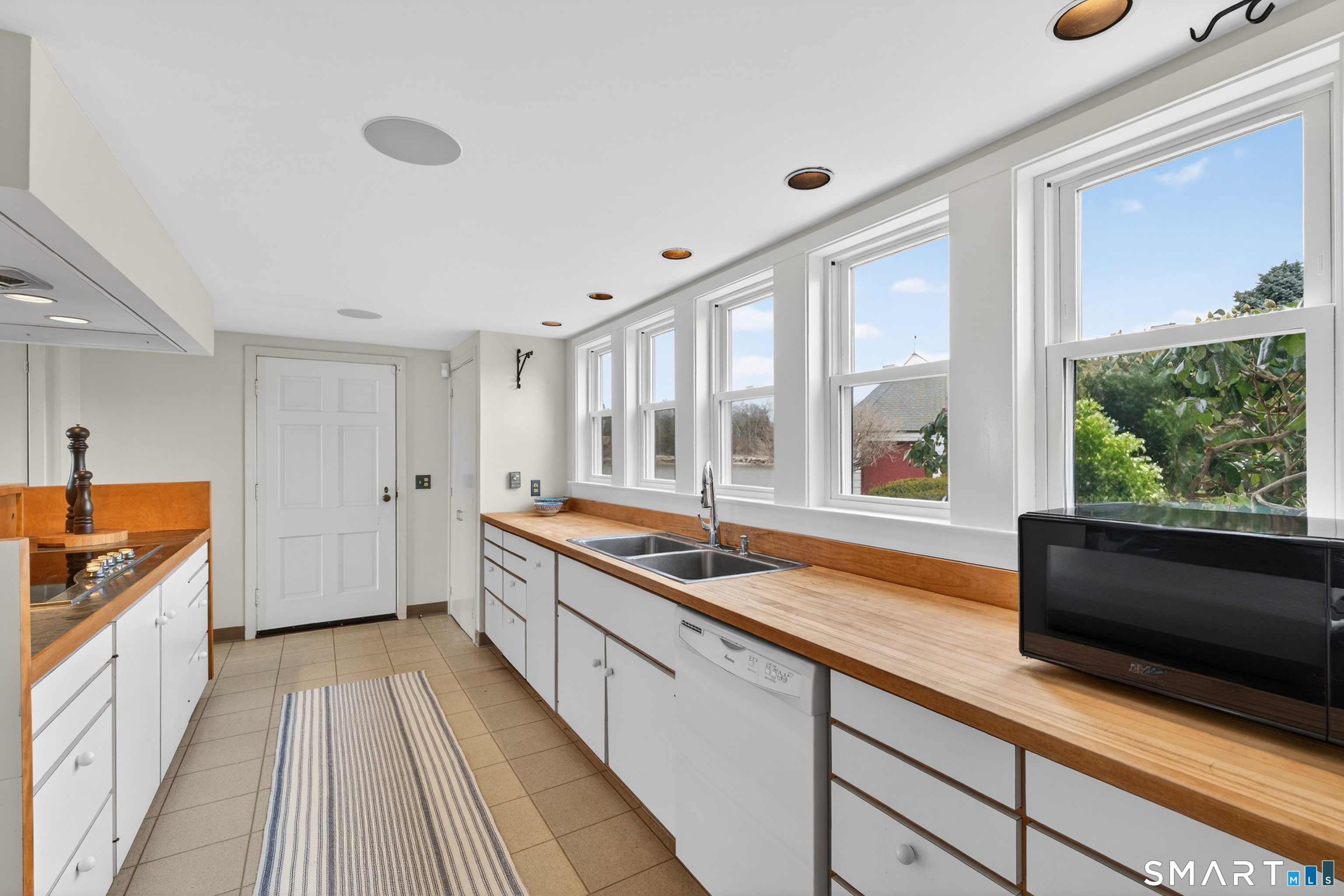 39 Vineyard Place Guilford, CT 06437 - Photo 13 of 41 a large kitchen with a large window and stainless steel appliances
