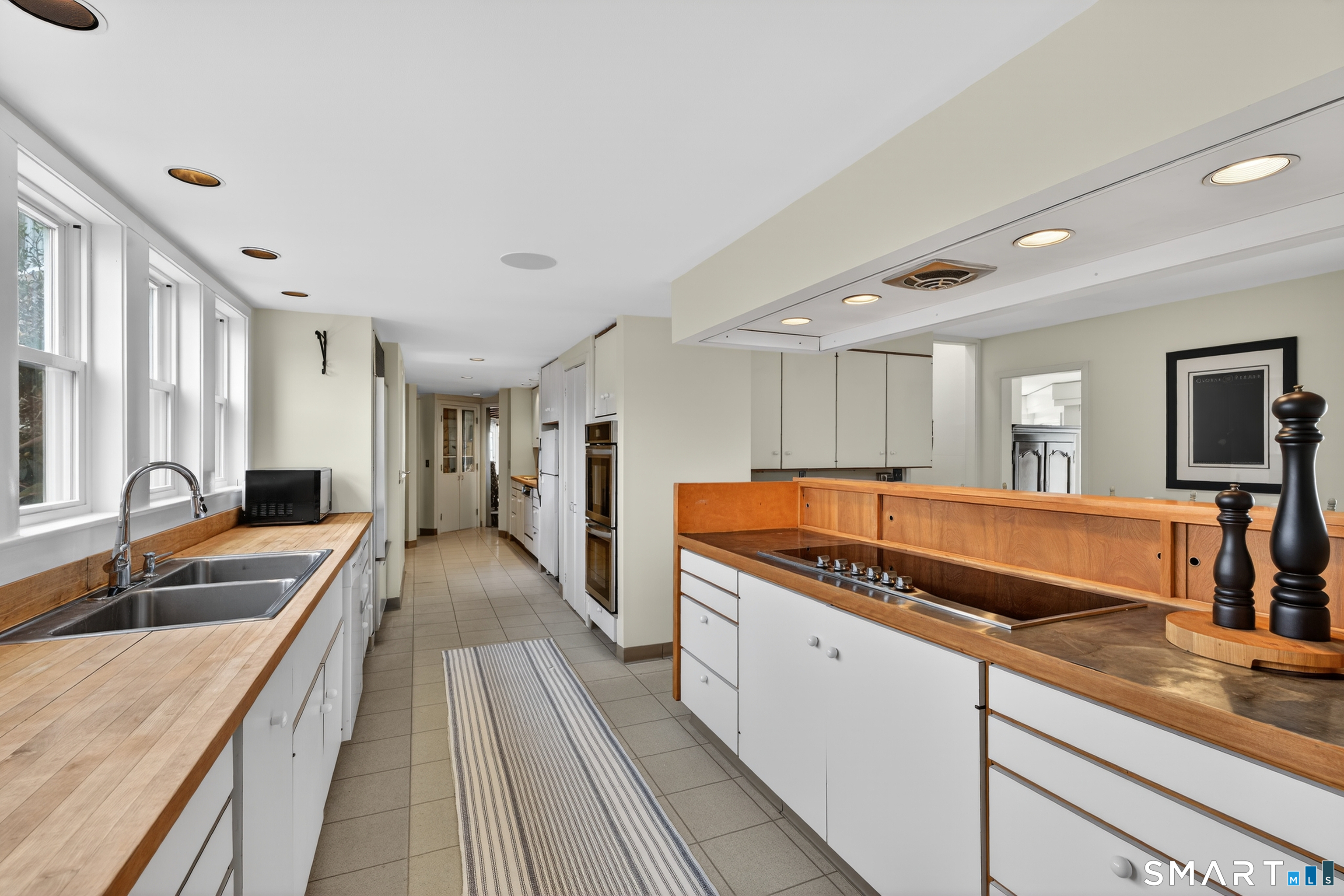 39 Vineyard Place Guilford, CT 06437 - Photo 14 of 41 a large kitchen with stainless steel appliances granite countertop a lot of counter space and wooden floors