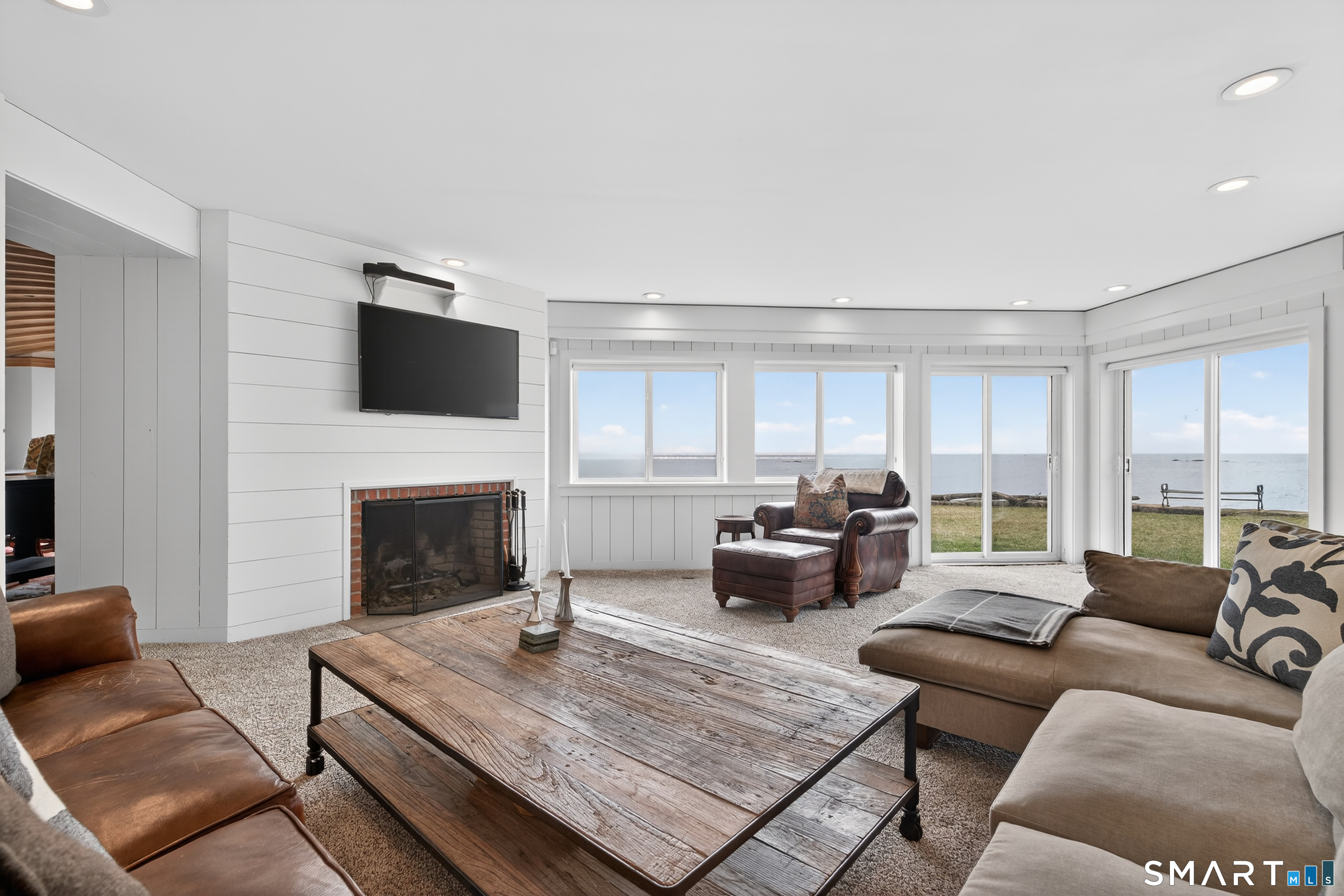 39 Vineyard Place Guilford, CT 06437 - Photo 18 of 41 a living room with furniture fireplace and a flat screen tv