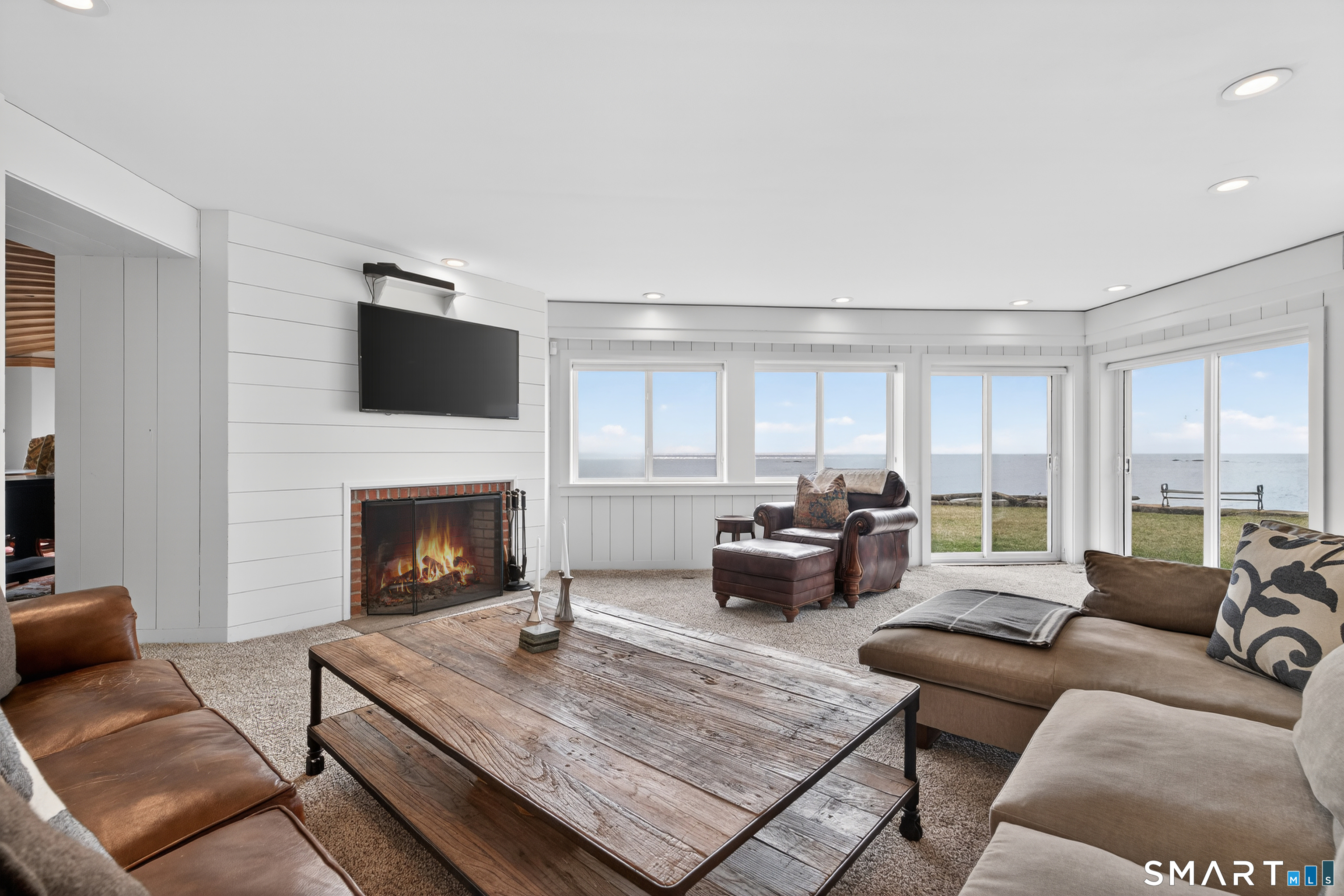 39 Vineyard Place Guilford, CT 06437 - Photo 19 of 41 a living room with furniture and a fireplace
