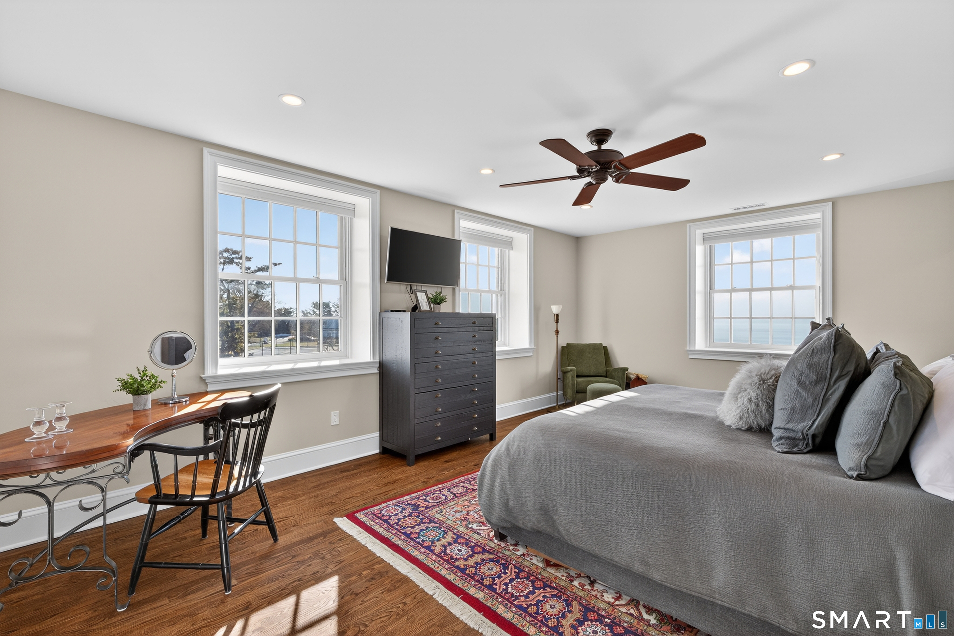39 Vineyard Place Guilford, CT 06437 - Photo 21 of 41 a bedroom with a bed and a chandelier