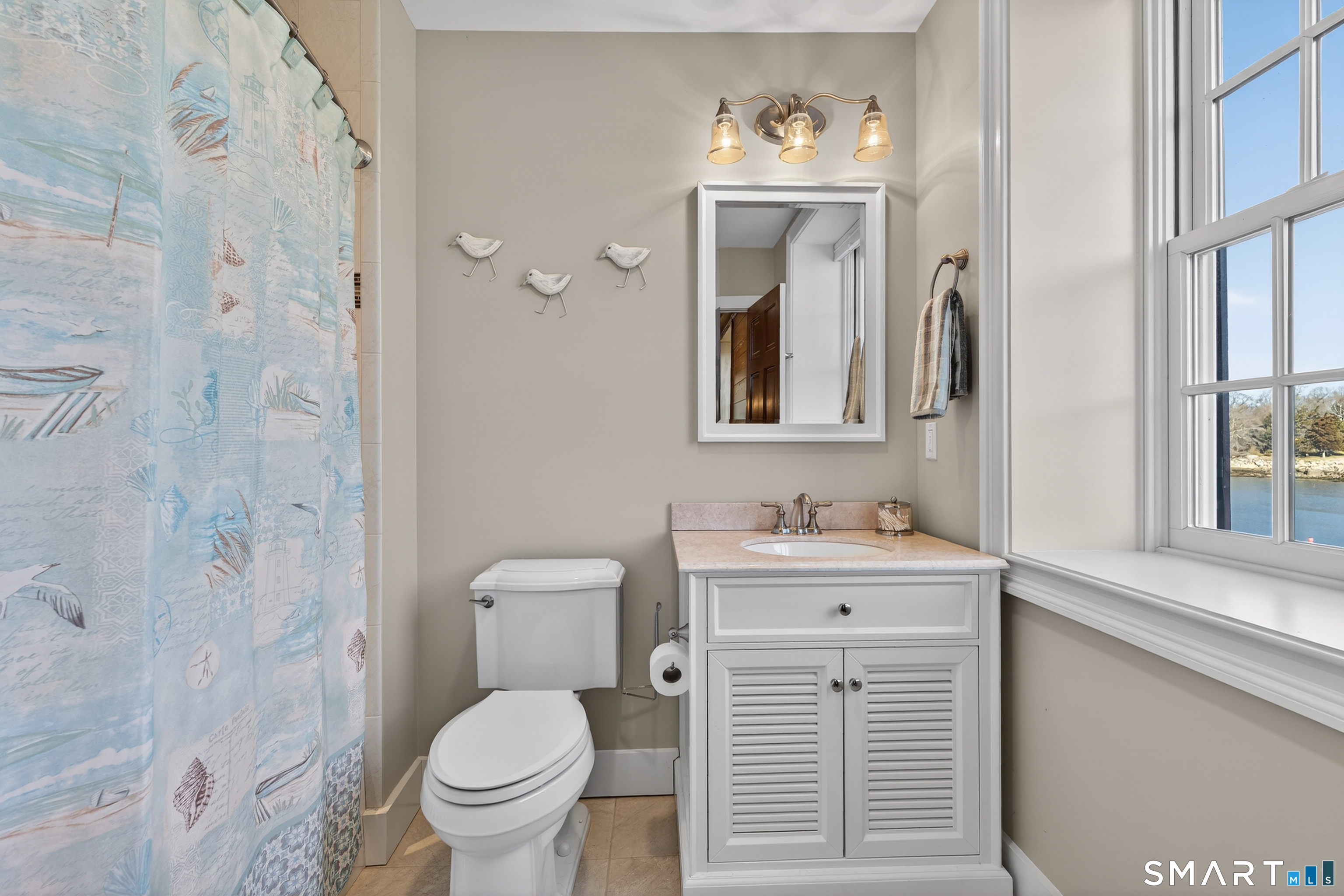 39 Vineyard Place Guilford, CT 06437 - Photo 25 of 41 a bathroom with a toilet a sink and mirror
