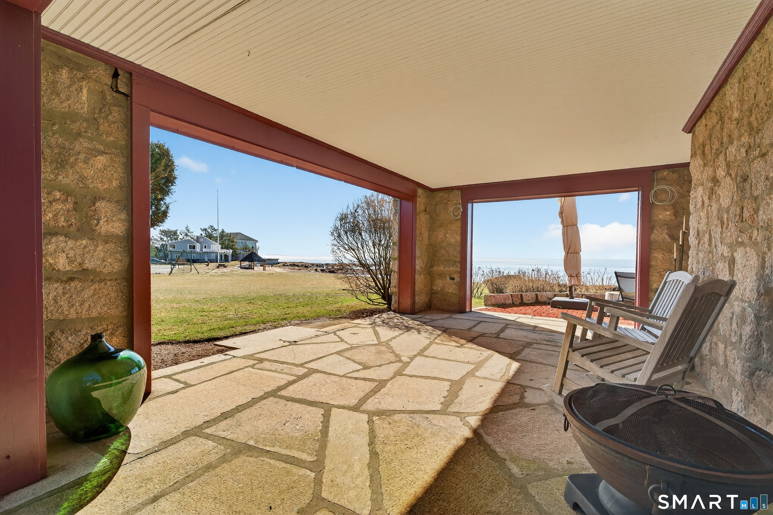 39 Vineyard Place Guilford, CT 06437 - Photo 35 of 41 a living room with couches floor to ceiling window and a table
